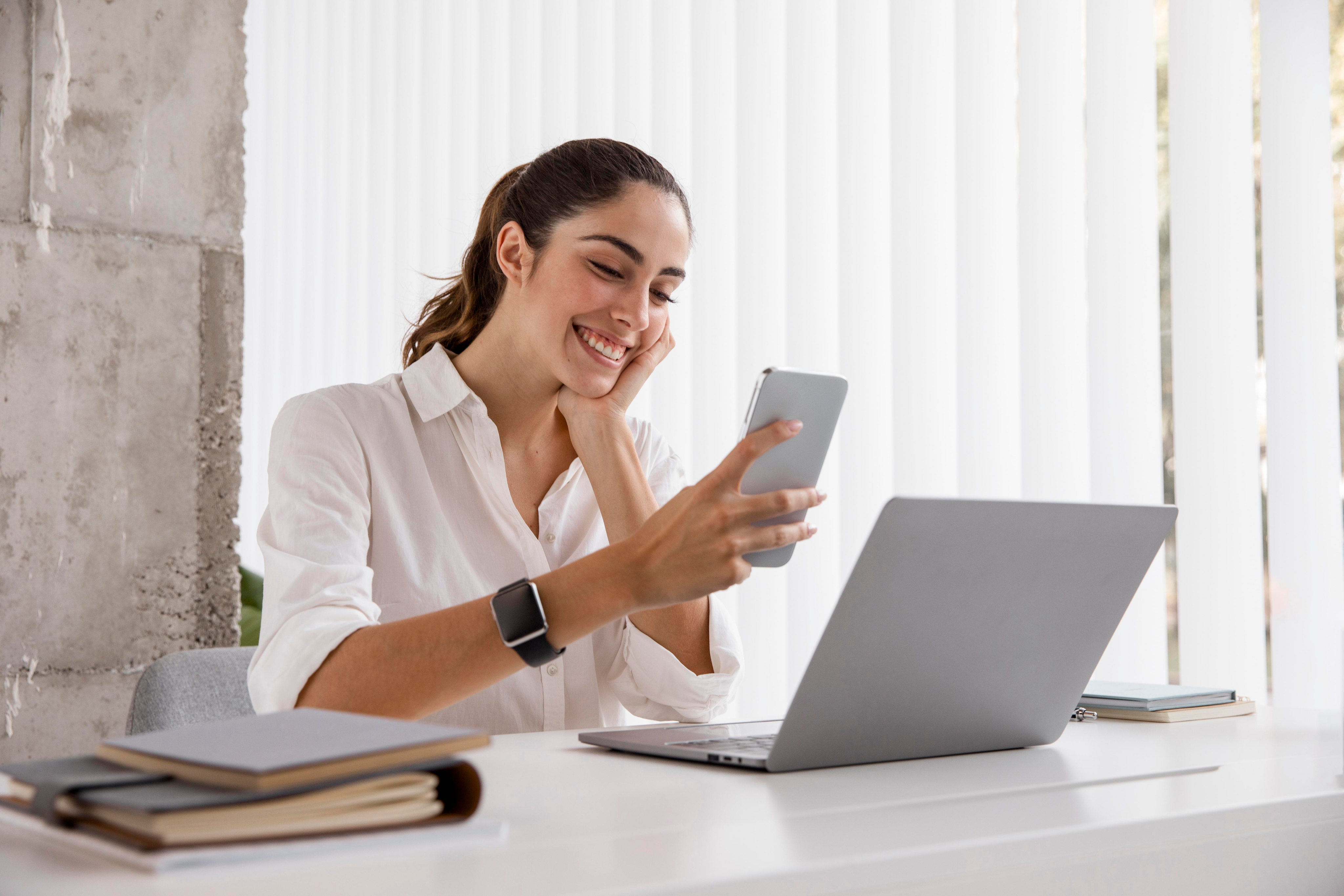Businesswoman with smartphone and laptop
